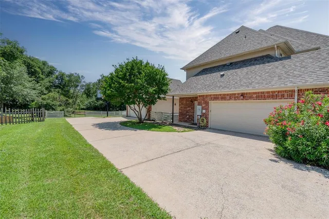 a front view of a house with a yard and a garage