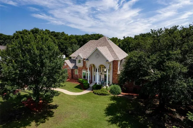 a aerial view of a house with a yard and a fountain