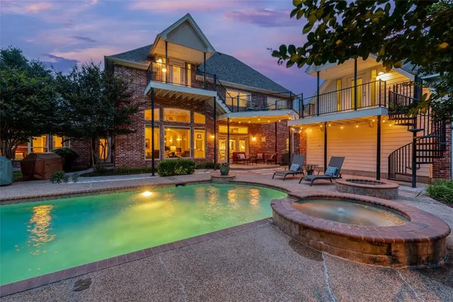 a view of a house with swimming pool and sitting area