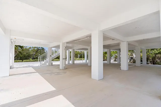 a view of a house with porch and garden