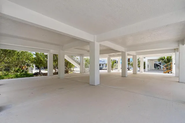 a view of a house with porch and garden