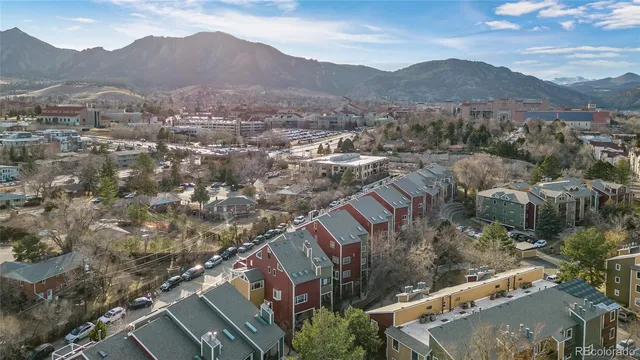 a balcony with wooden floor and trees in the back