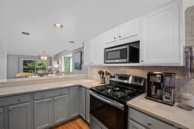 a kitchen with stainless steel appliances granite countertop a sink refrigerator and microwave