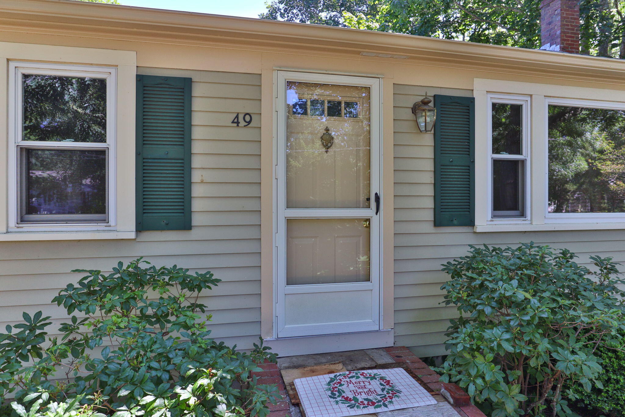 front view of a house with a potted plant