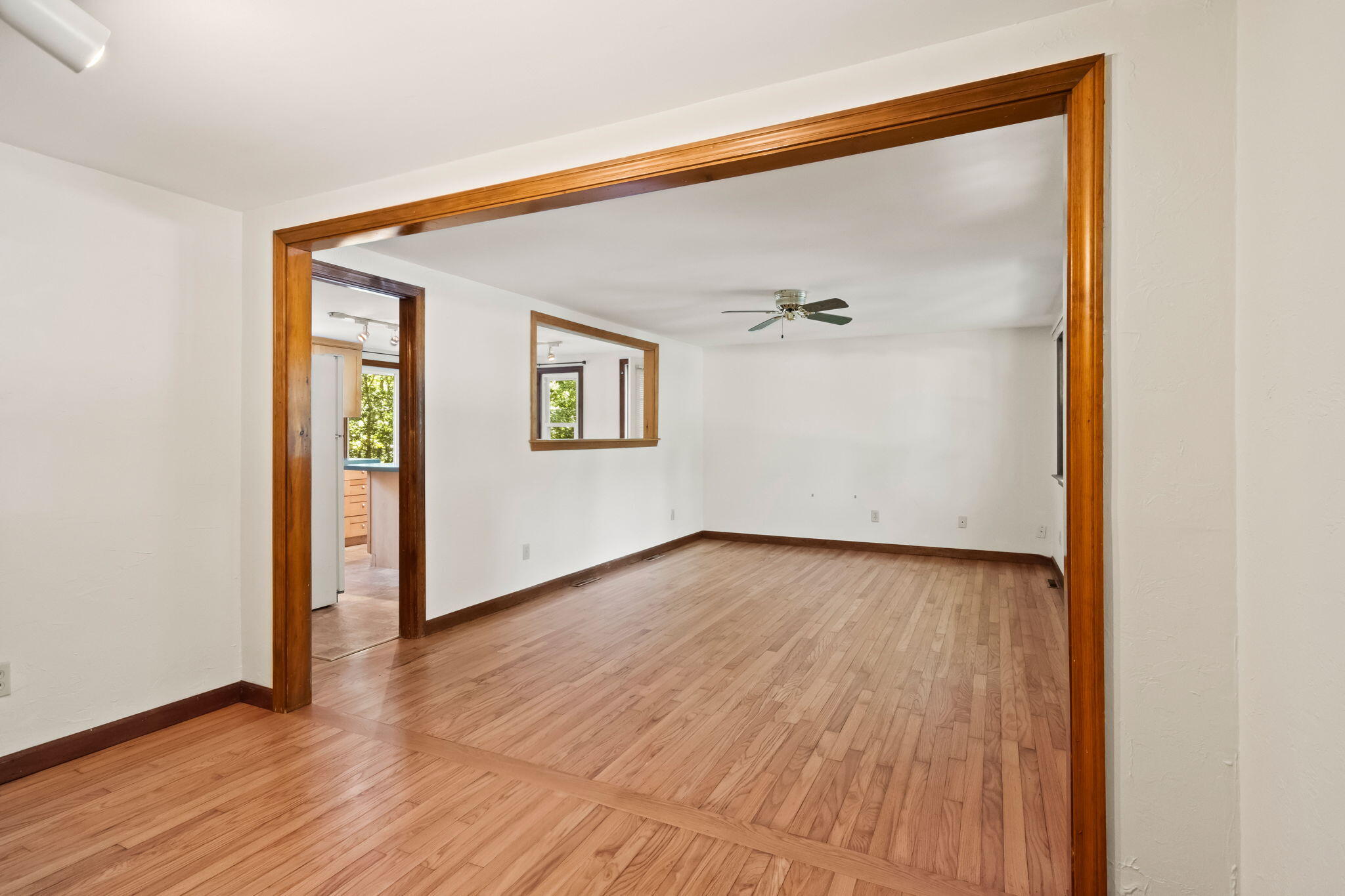 49 Russells Path Brewster, MA 02631 - Photo 11 of 37 an empty room with wooden floor and windows