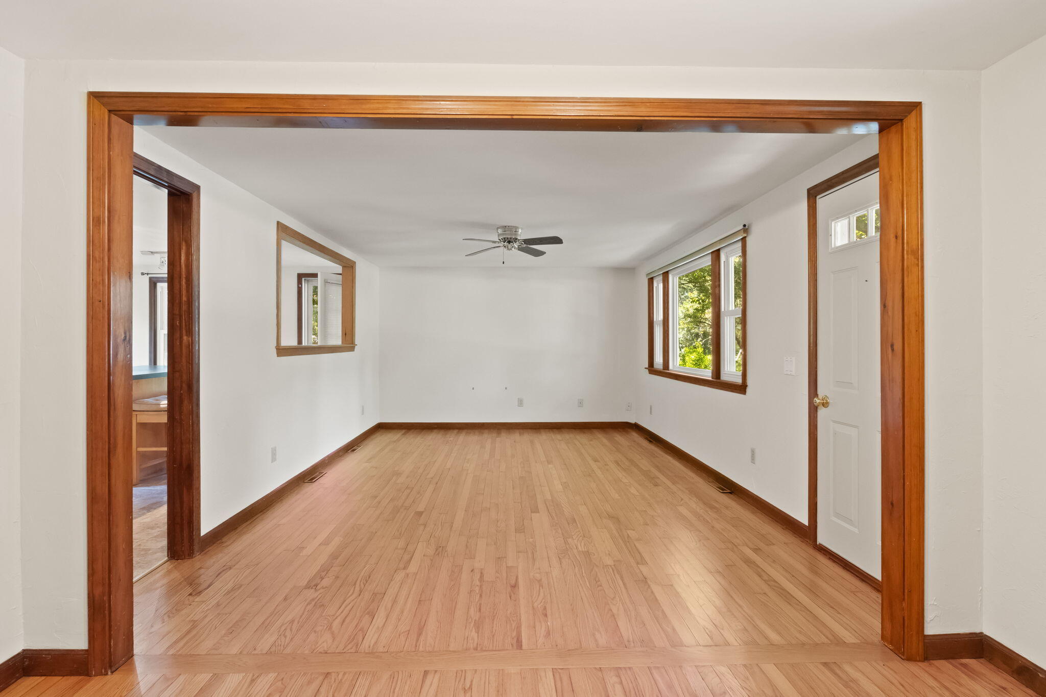 49 Russells Path Brewster, MA 02631 - Photo 12 of 37 a view of an empty room with wooden floor and a window