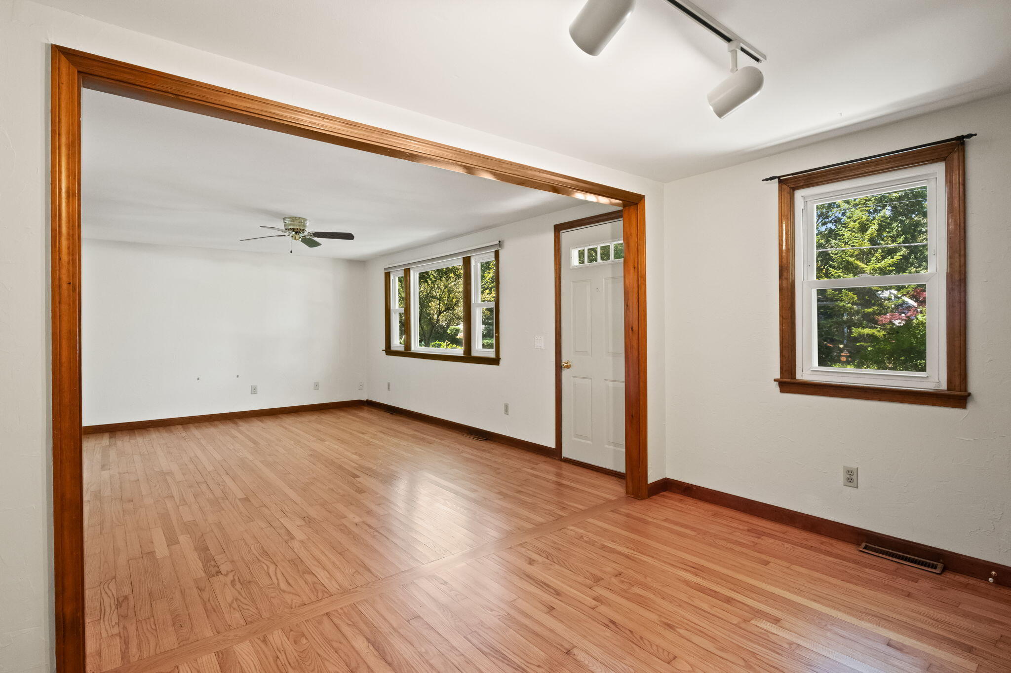49 Russells Path Brewster, MA 02631 - Photo 13 of 37 a view of an empty room with wooden floor and a window