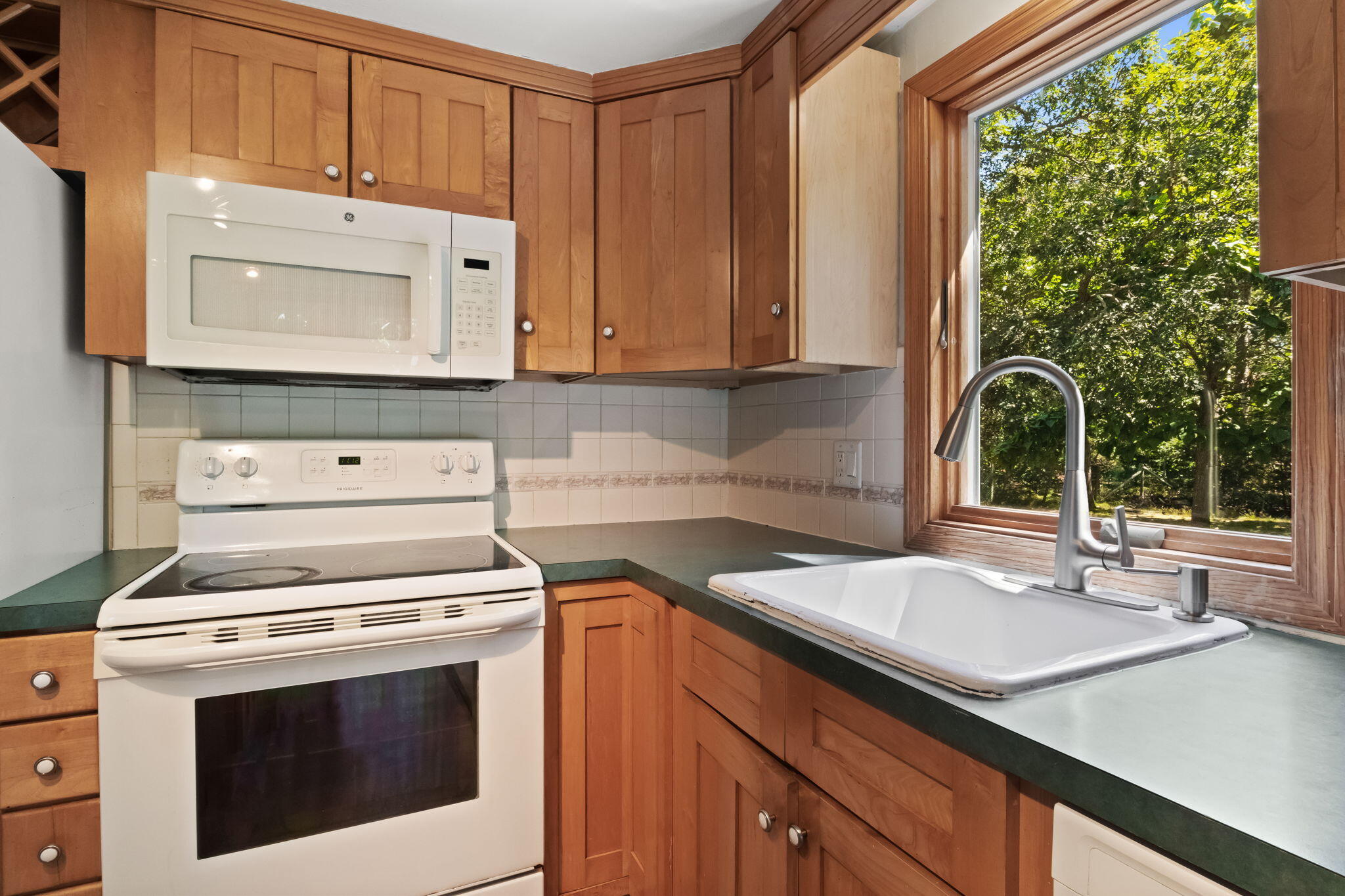 49 Russells Path Brewster, MA 02631 - Photo 17 of 37 a kitchen with a stove and a white cabinets