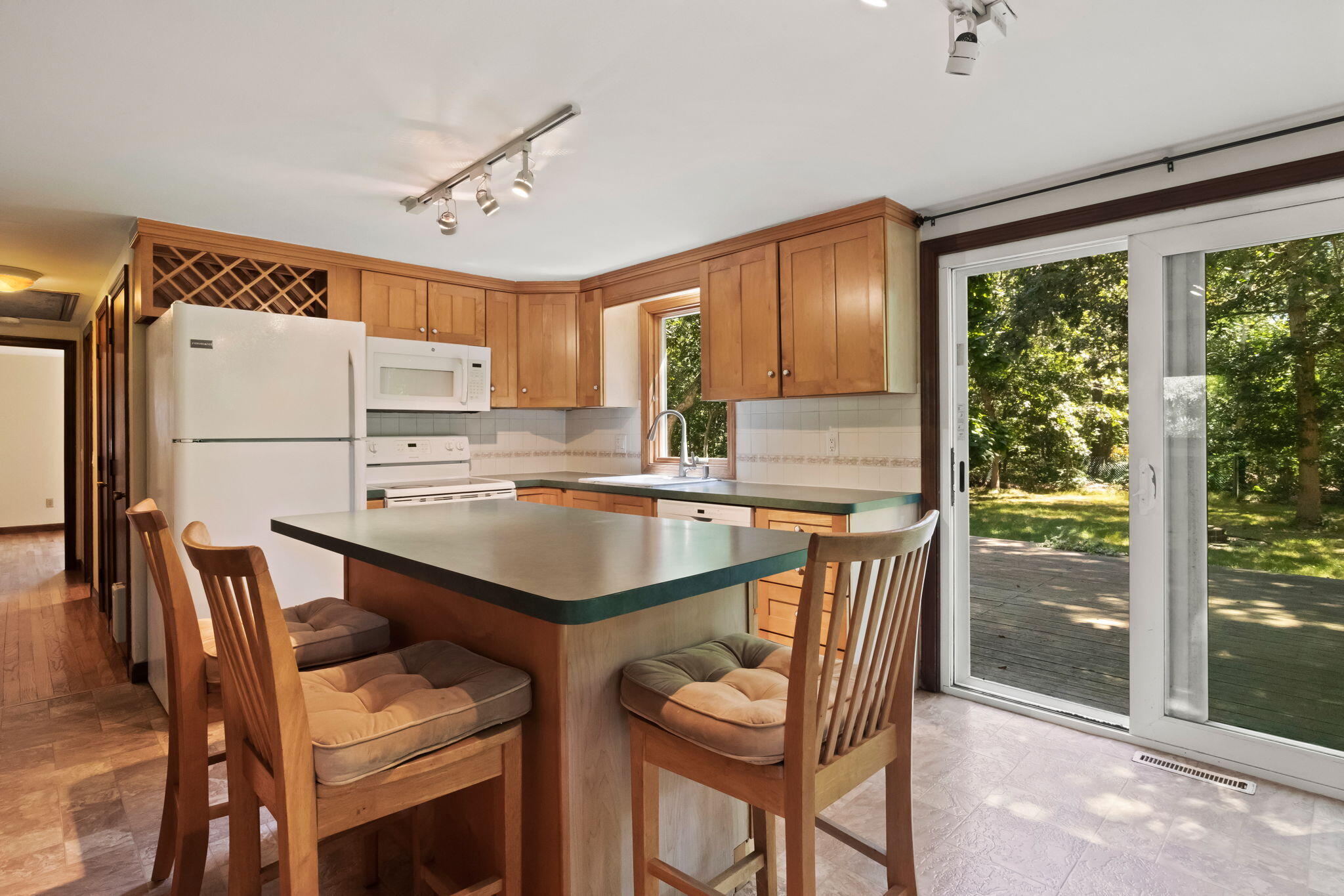 49 Russells Path Brewster, MA 02631 - Photo 18 of 37 a kitchen with a table chairs refrigerator and cabinets