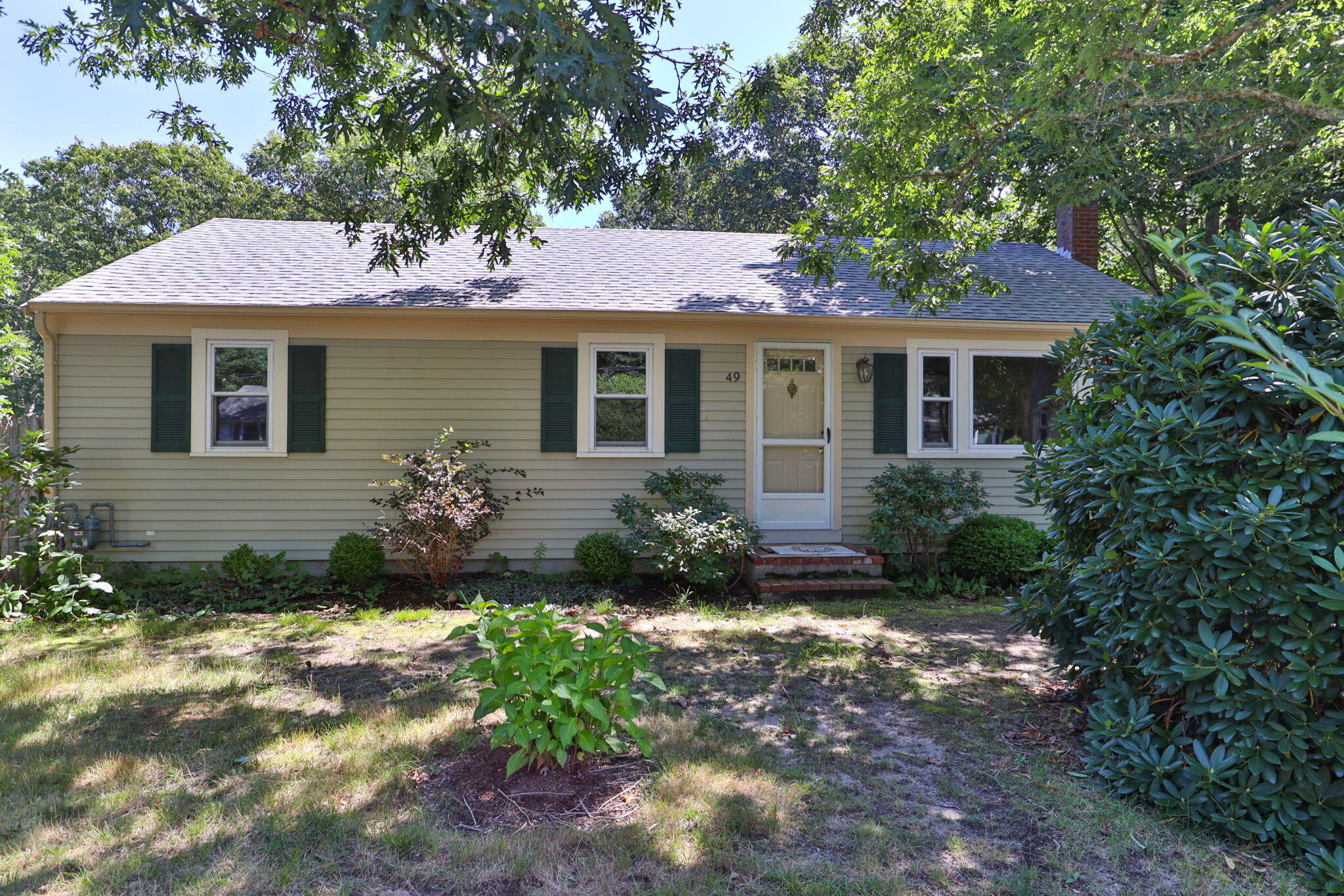 49 Russells Path Brewster, MA 02631 - Photo 2 of 37 a front view of a house with a yard