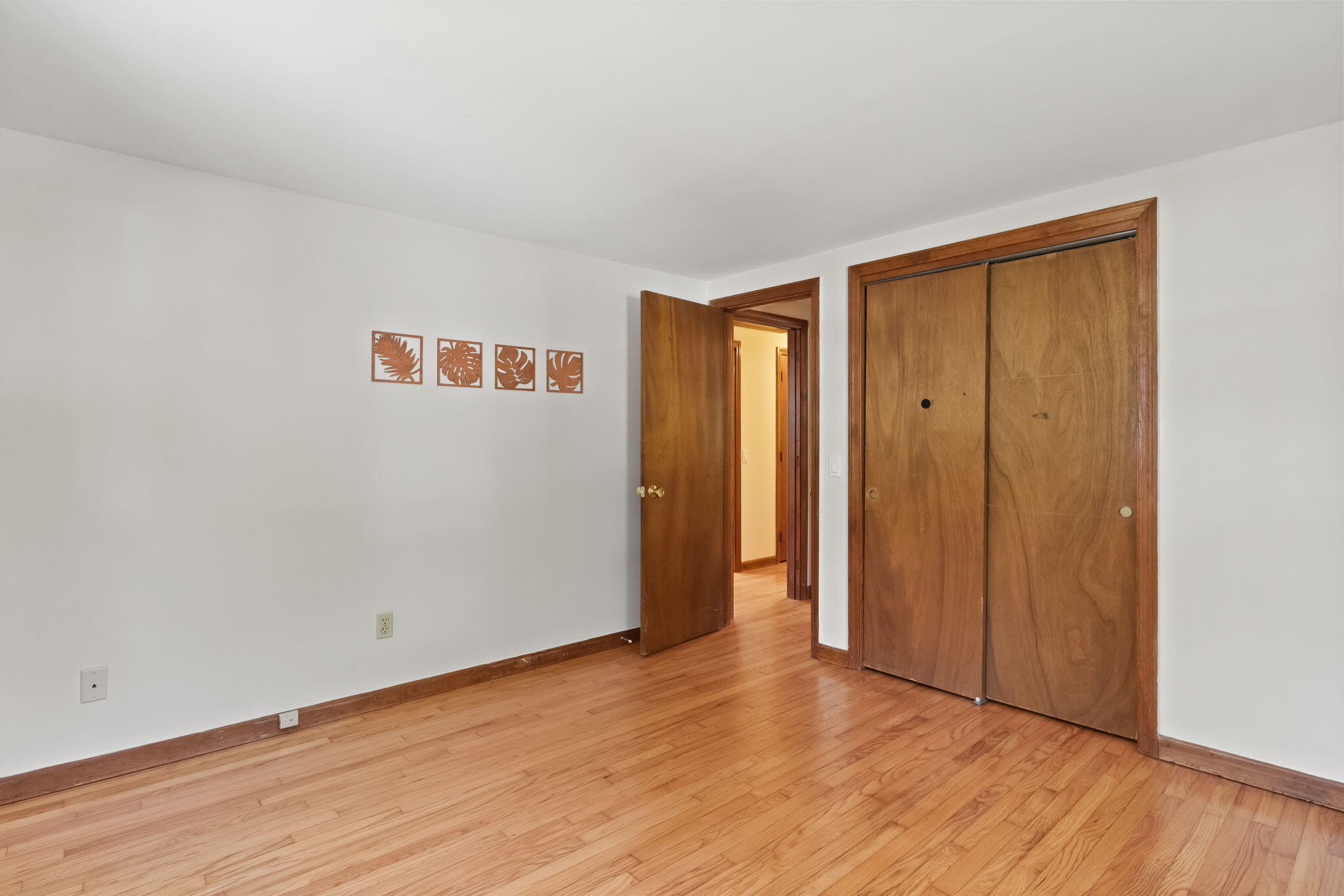 49 Russells Path Brewster, MA 02631 - Photo 24 of 37 a view of an empty room with wooden floor and closet