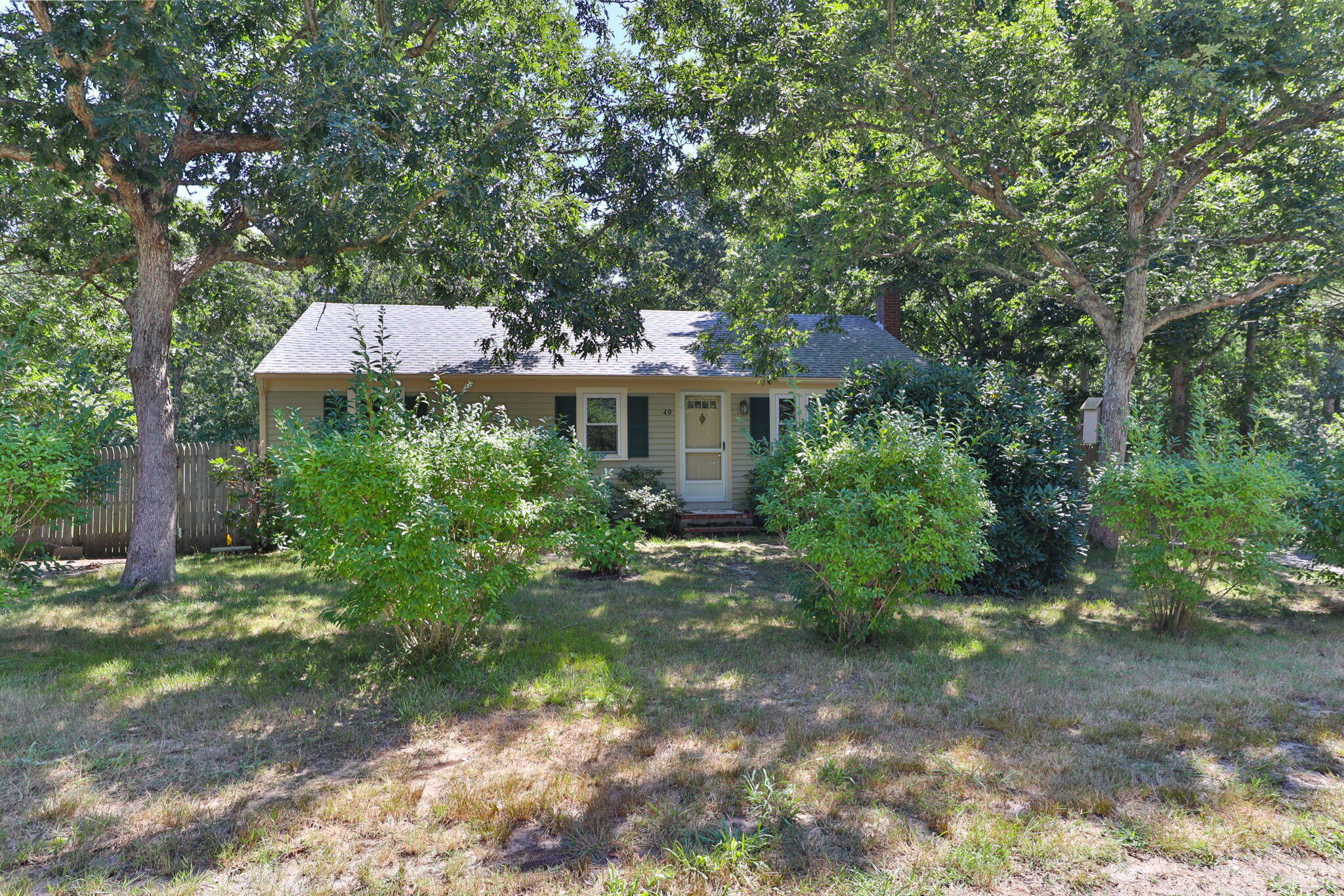 49 Russells Path Brewster, MA 02631 - Photo 3 of 37 a front view of a house with a yard