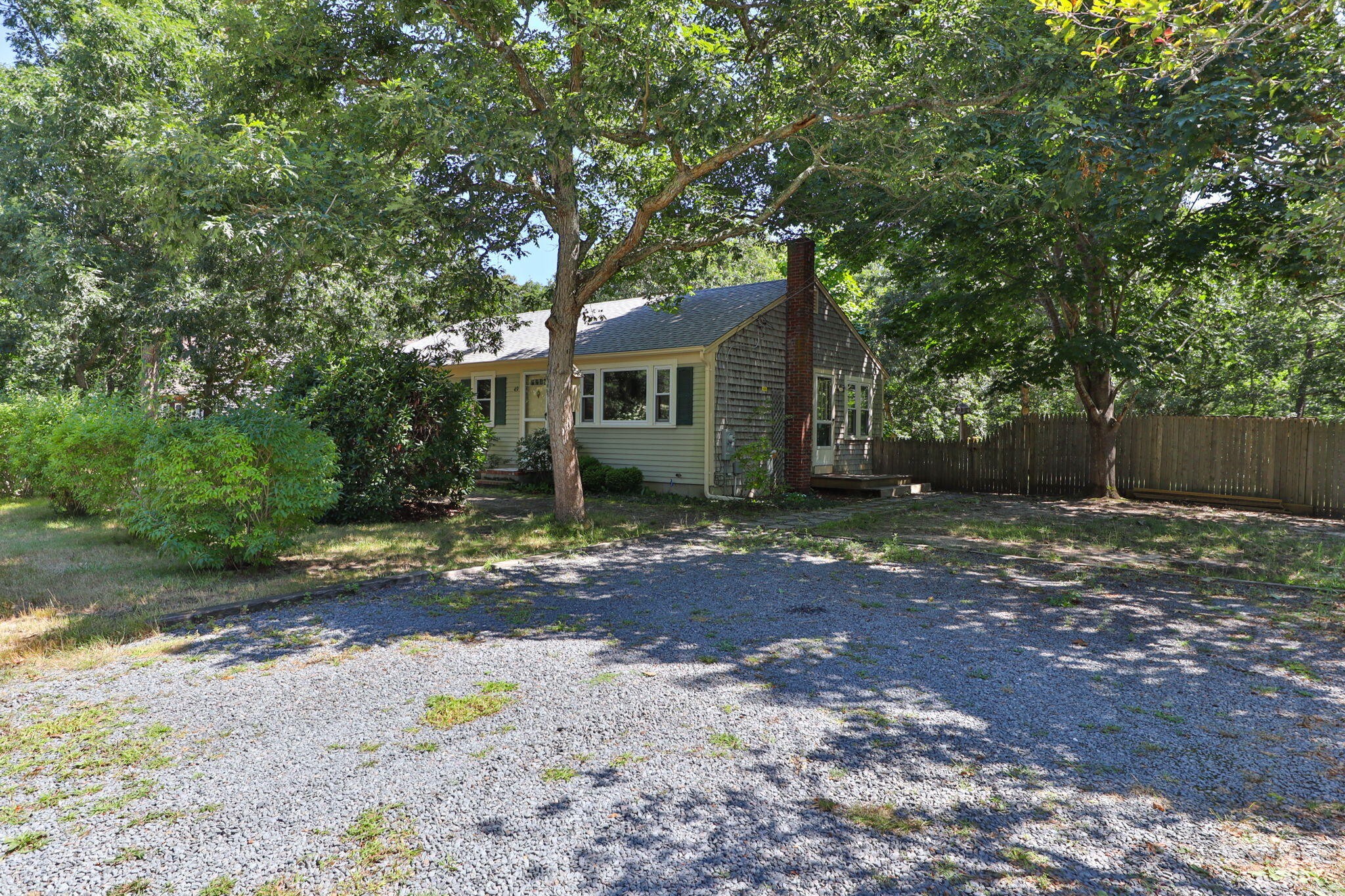 49 Russells Path Brewster, MA 02631 - Photo 5 of 37 a view of a house with yard and a tree
