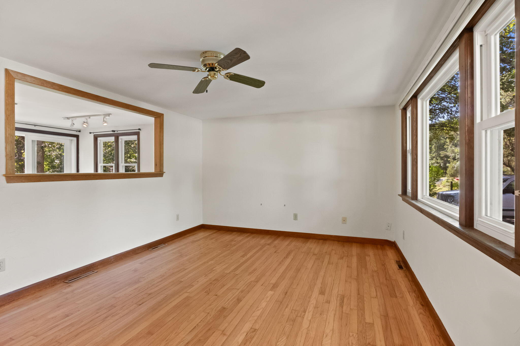 49 Russells Path Brewster, MA 02631 - Photo 8 of 37 a view of an empty room with wooden floor and a window
