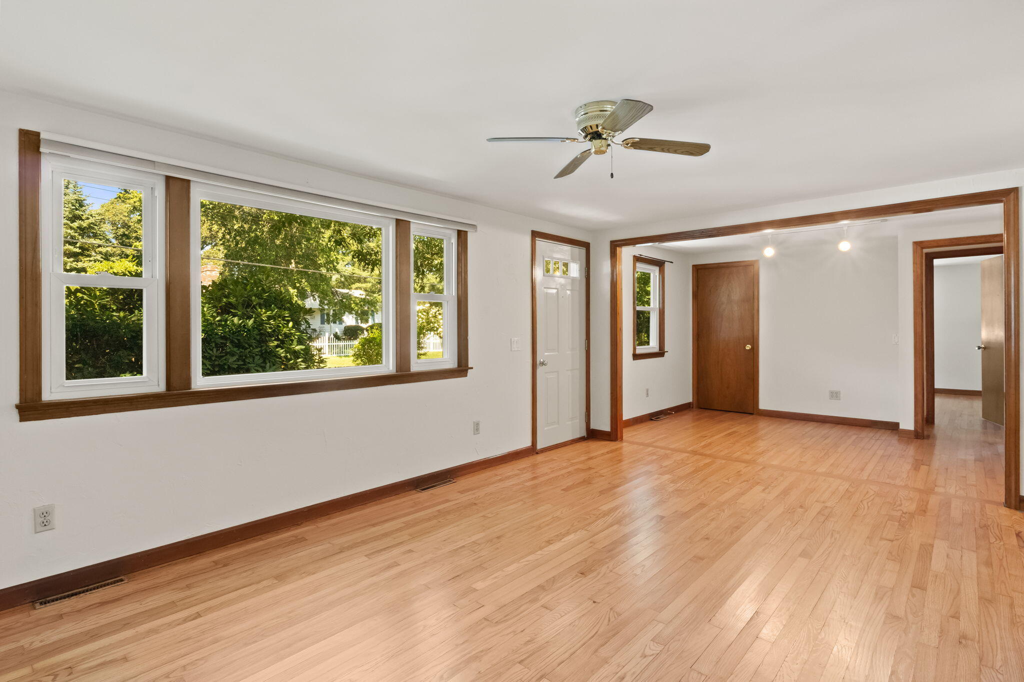 49 Russells Path Brewster, MA 02631 - Photo 9 of 37 a view of an empty room with a window and wooden floor
