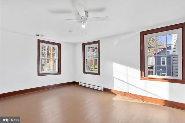 an empty room with a empty space and a ceiling fan