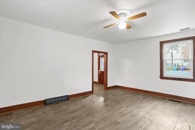wooden floor in an empty room with a window