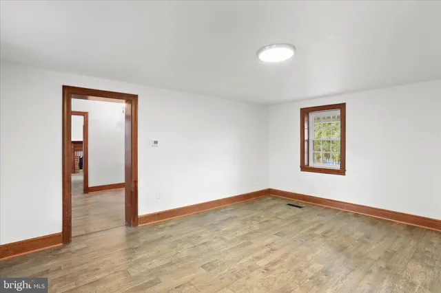 an empty room with windows and closet