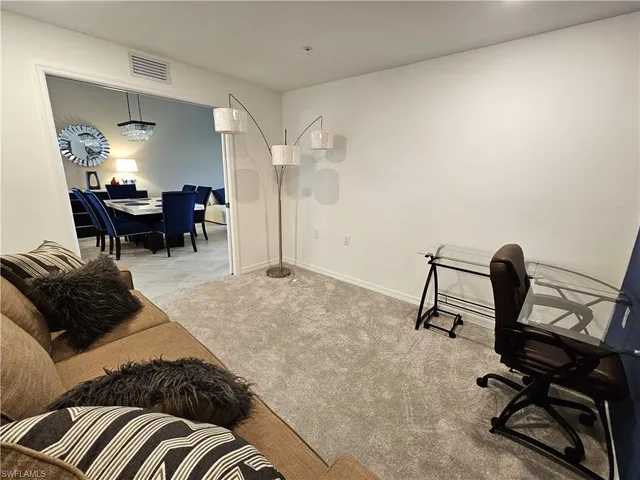 a living room with furniture and a piano