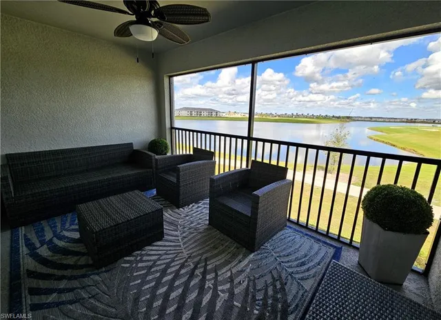 a living room with furniture and a floor to ceiling window