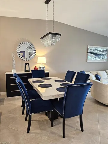 a view of a dining room with a table and chairs