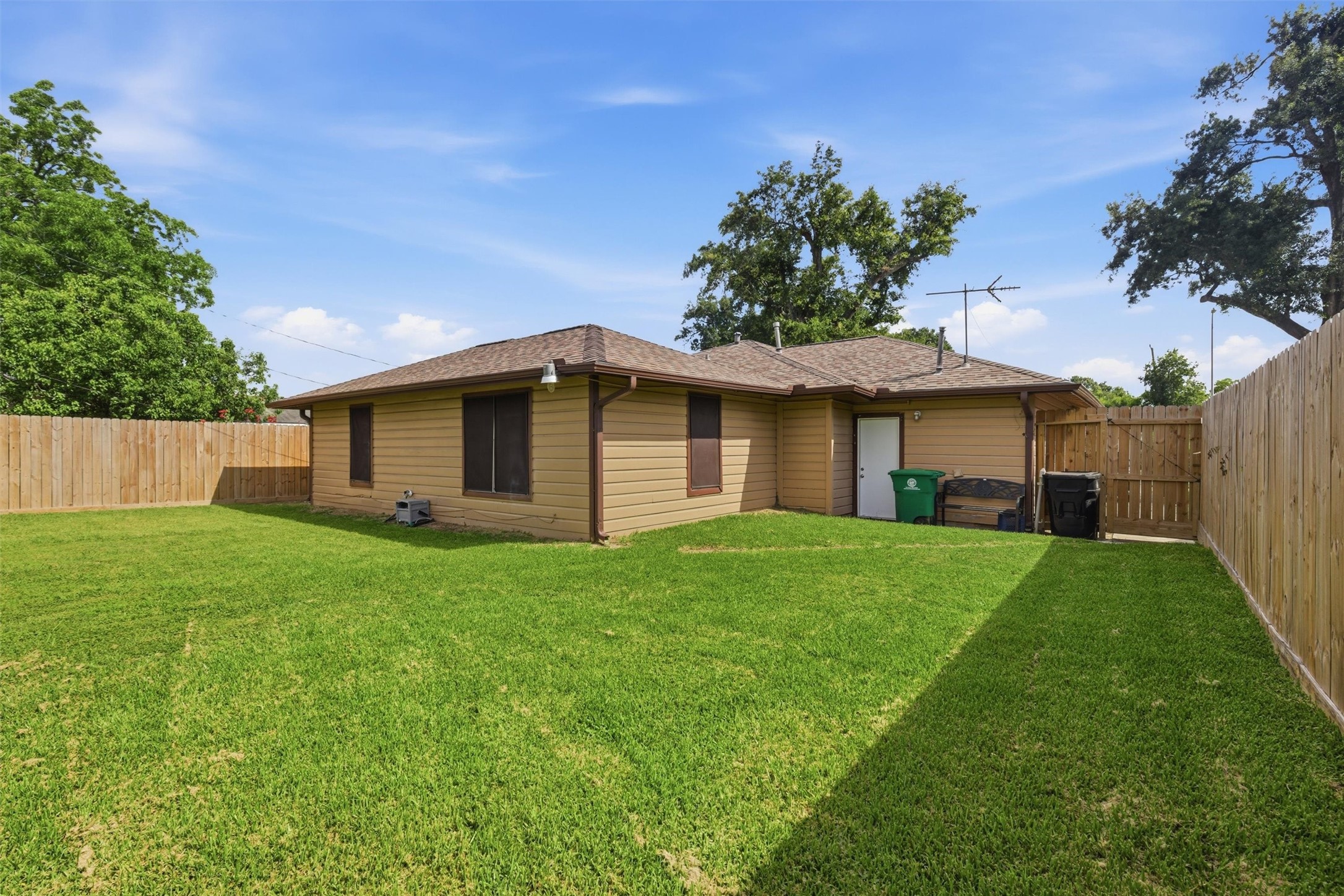 3615 Alberta Street Houston, TX 77021 - Photo 15 of 16 a view of a yard in front of a house with plants and large tree