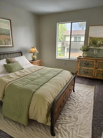 a bedroom with a bed and a window