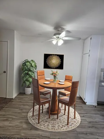 a view of a workspace with furniture and wooden floor