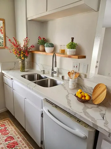 a kitchen with sink and cabinets