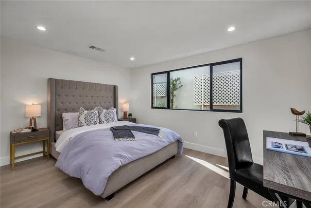 a bedroom with a bed a desk and chair