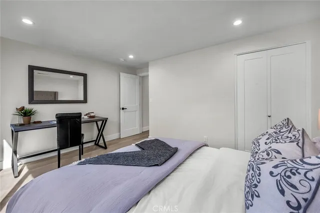 a bedroom with a bed and a desk in it