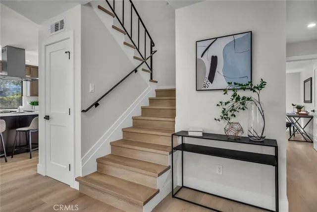 a living room with wooden floor and potted plants