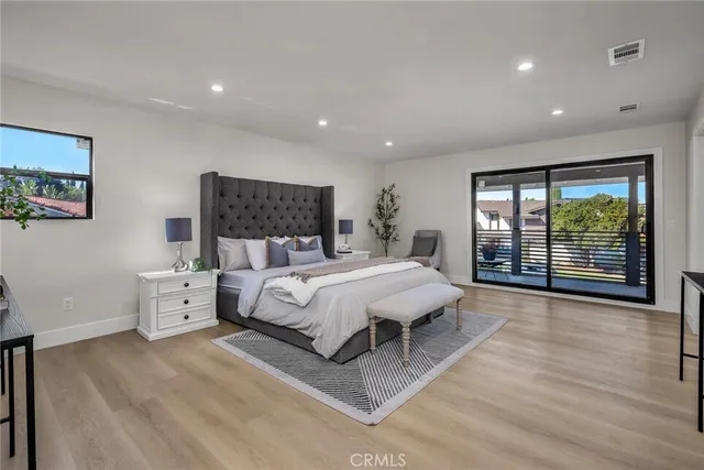 a spacious bedroom with a large bed and a large window