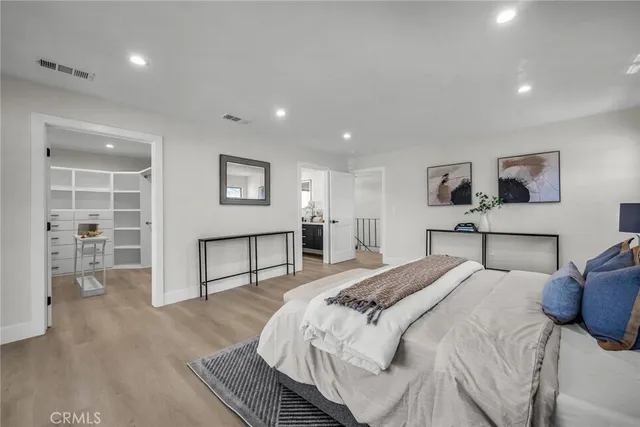 a bedroom with a bed and a night stand