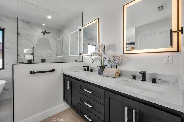 a bathroom with a sink double vanity and a mirror