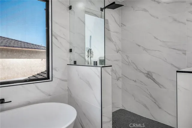 a bathroom with a sink and glass door shower
