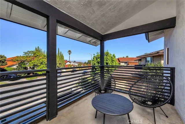 a view of a balcony with chairs