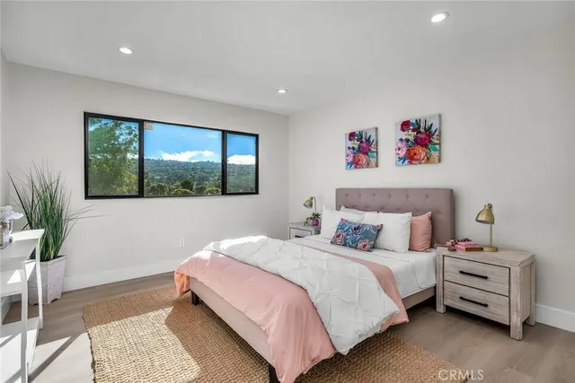 a bedroom with a bed and a large window