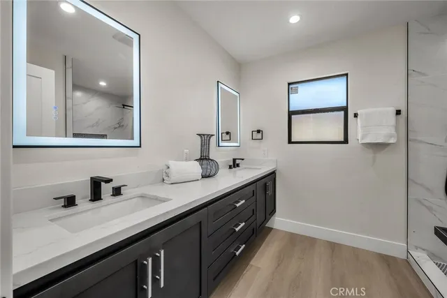 a bathroom with a double vanity sink and mirror