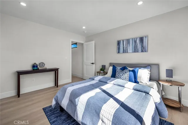 a bedroom with a bed and a night stand