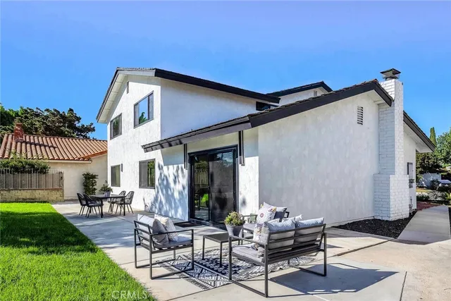 a backyard of a house with table and chairs