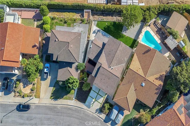 an aerial view of a house with garden space and street view