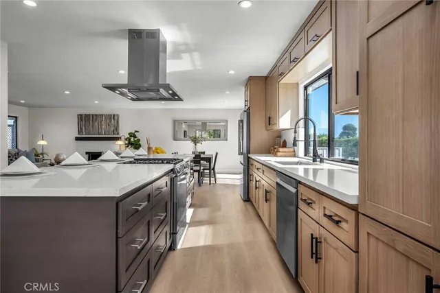 a large kitchen with stainless steel appliances lots of counter space and a sink