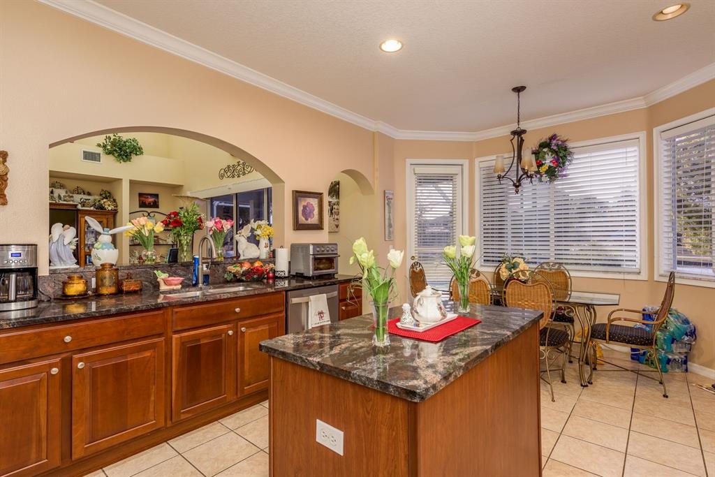 19216 Inlet Cove Court Lutz, FL 33558 - Photo 14 of 41 a kitchen that has a lot of cabinets a sink and a dining table with chairs