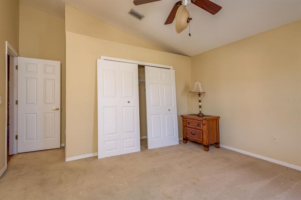 19216 Inlet Cove Court Lutz, FL 33558 - Photo 30 of 41 an empty room with windows and ceiling fan