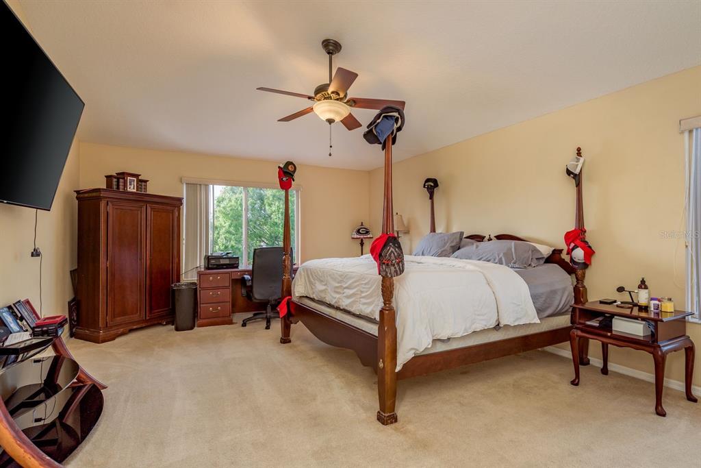 19216 Inlet Cove Court Lutz, FL 33558 - Photo 31 of 41 a bed room with a bed and a chair