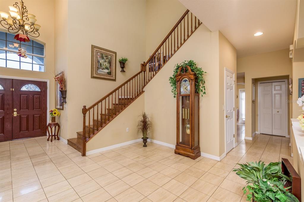 19216 Inlet Cove Court Lutz, FL 33558 - Photo 5 of 41 a view of staircase with lots of frames and flower garden