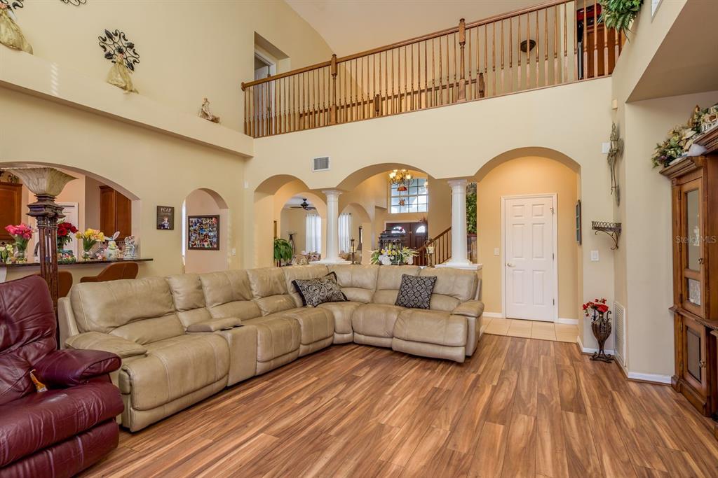 19216 Inlet Cove Court Lutz, FL 33558 - Photo 9 of 41 a living room with fireplace furniture and a wooden floor