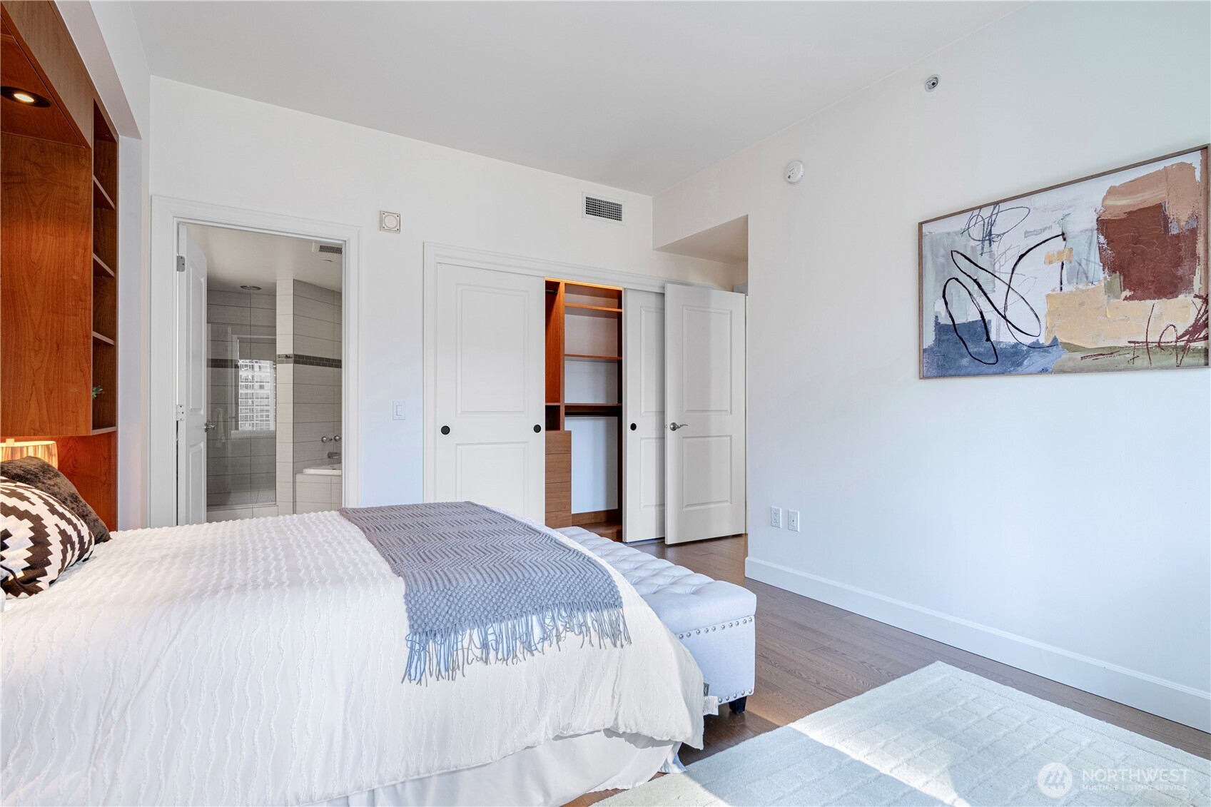 1920 4th Avenue, Unit 1809 Seattle, WA 98101 - Photo 14 of 30 a bedroom with a bed and a painting on the wall