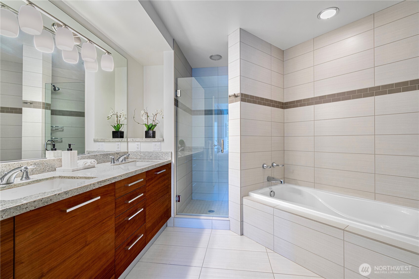 1920 4th Avenue, Unit 1809 Seattle, WA 98101 - Photo 15 of 30 a bathroom with a granite countertop bathtub sink vanity and mirror